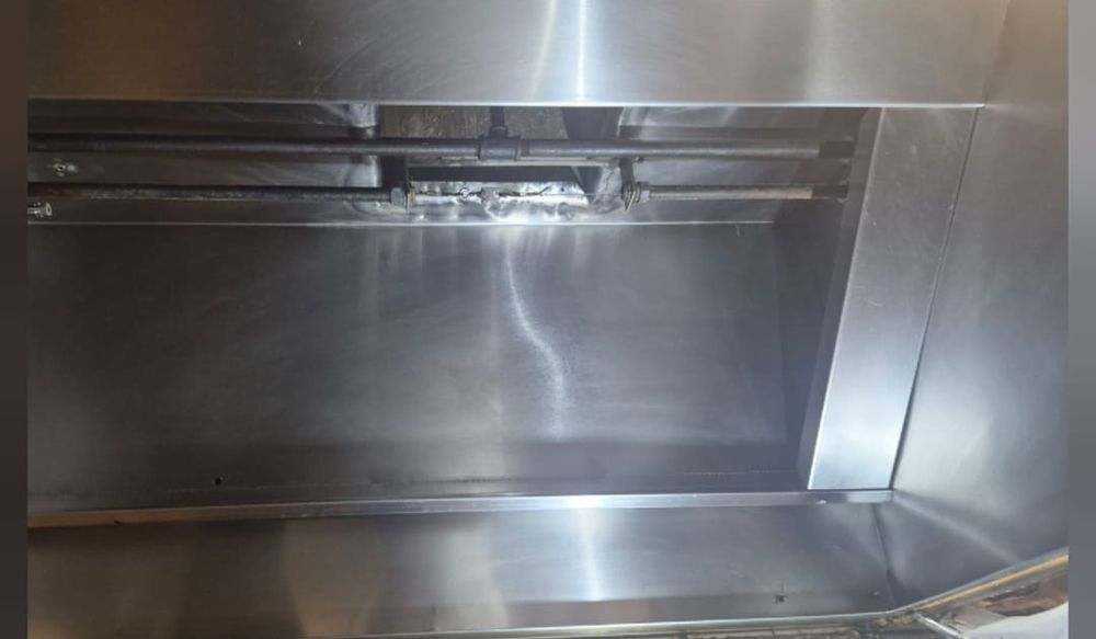 Freshly cleaned stainless-steel kitchen hood interior